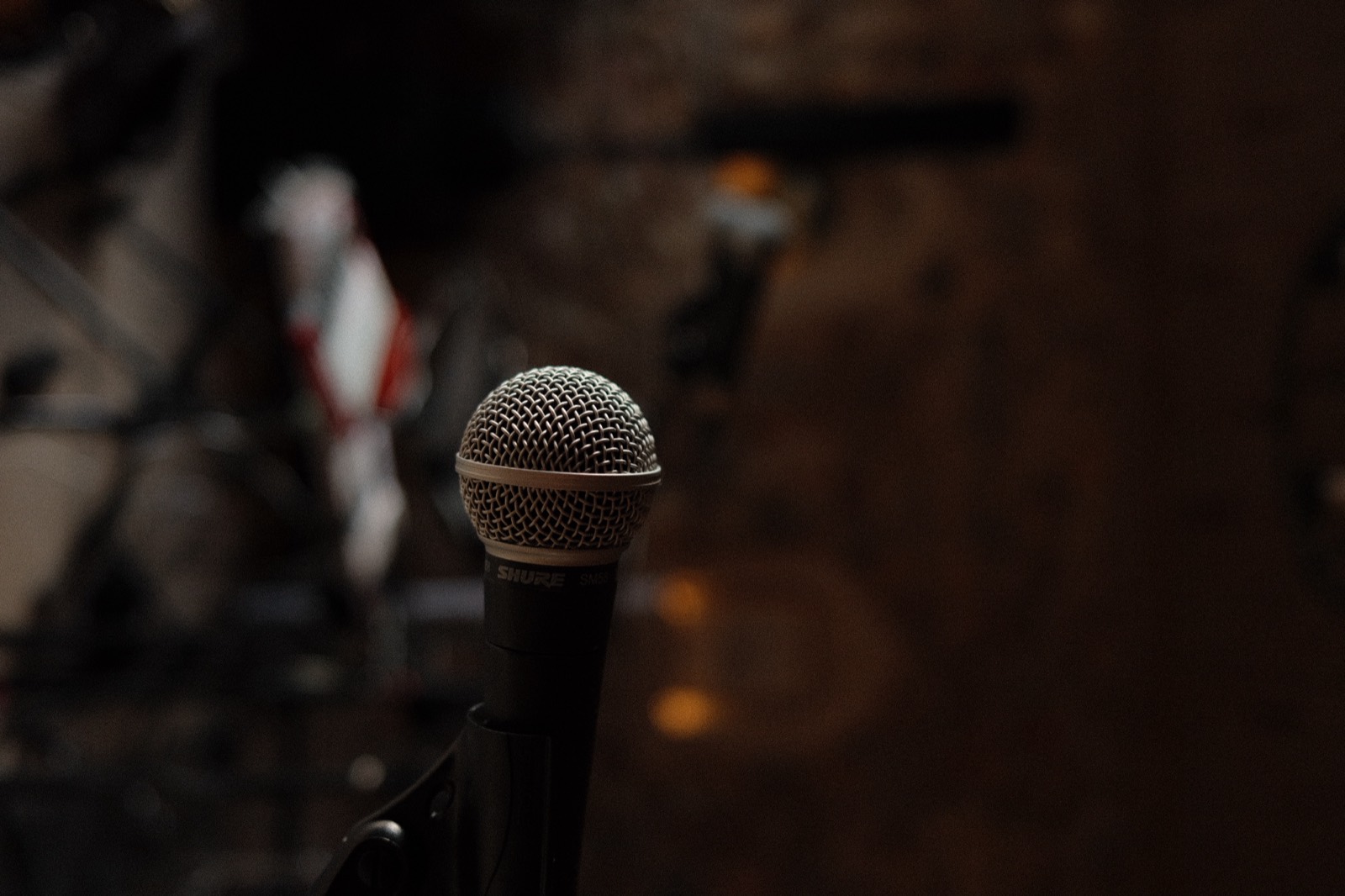 Close detail of a microphone on its stand in the warm low light of the chapel