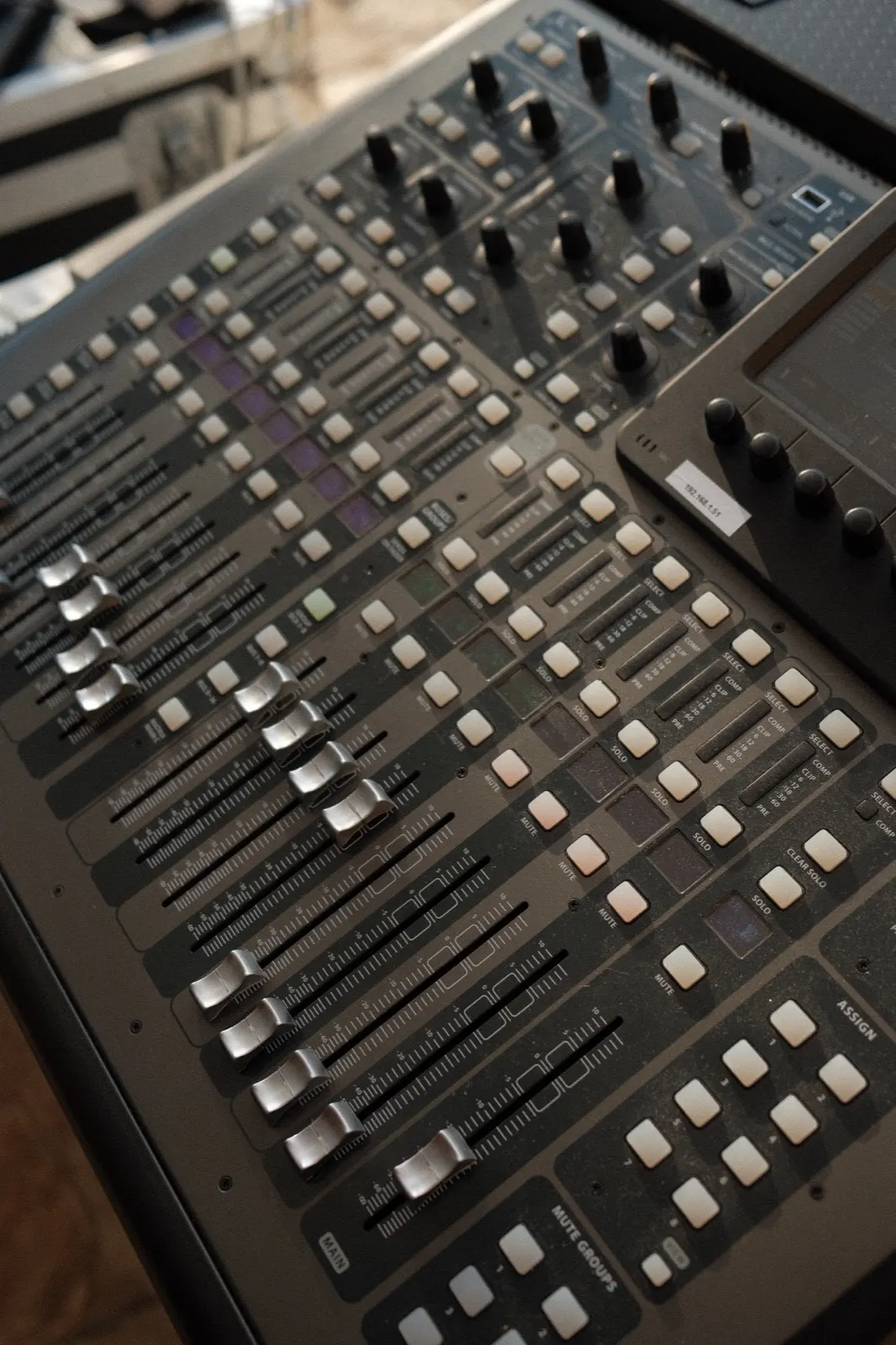 A mixing console with faders raised, capturing the live worship recording at The Hidden Encounter