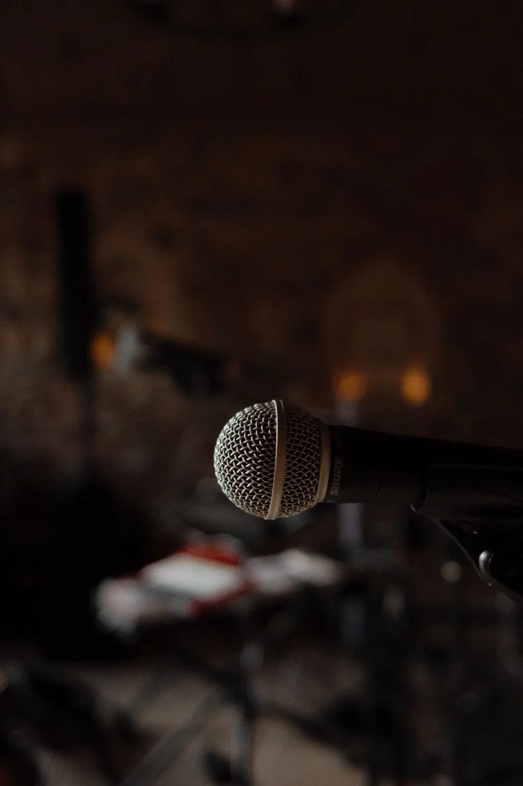 Close detail of a microphone on its stand in the warm low light of the chapel