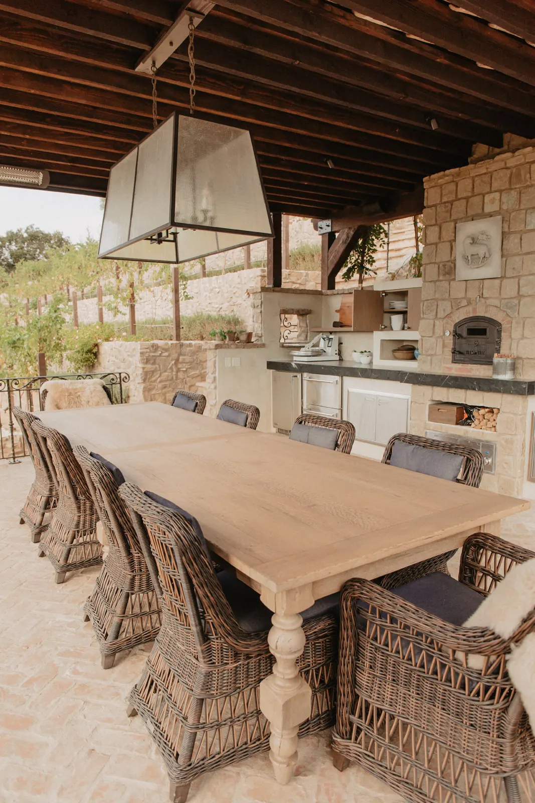 Long harvest table set outdoors on the grounds of The Hidden Encounter, surrounded by trees