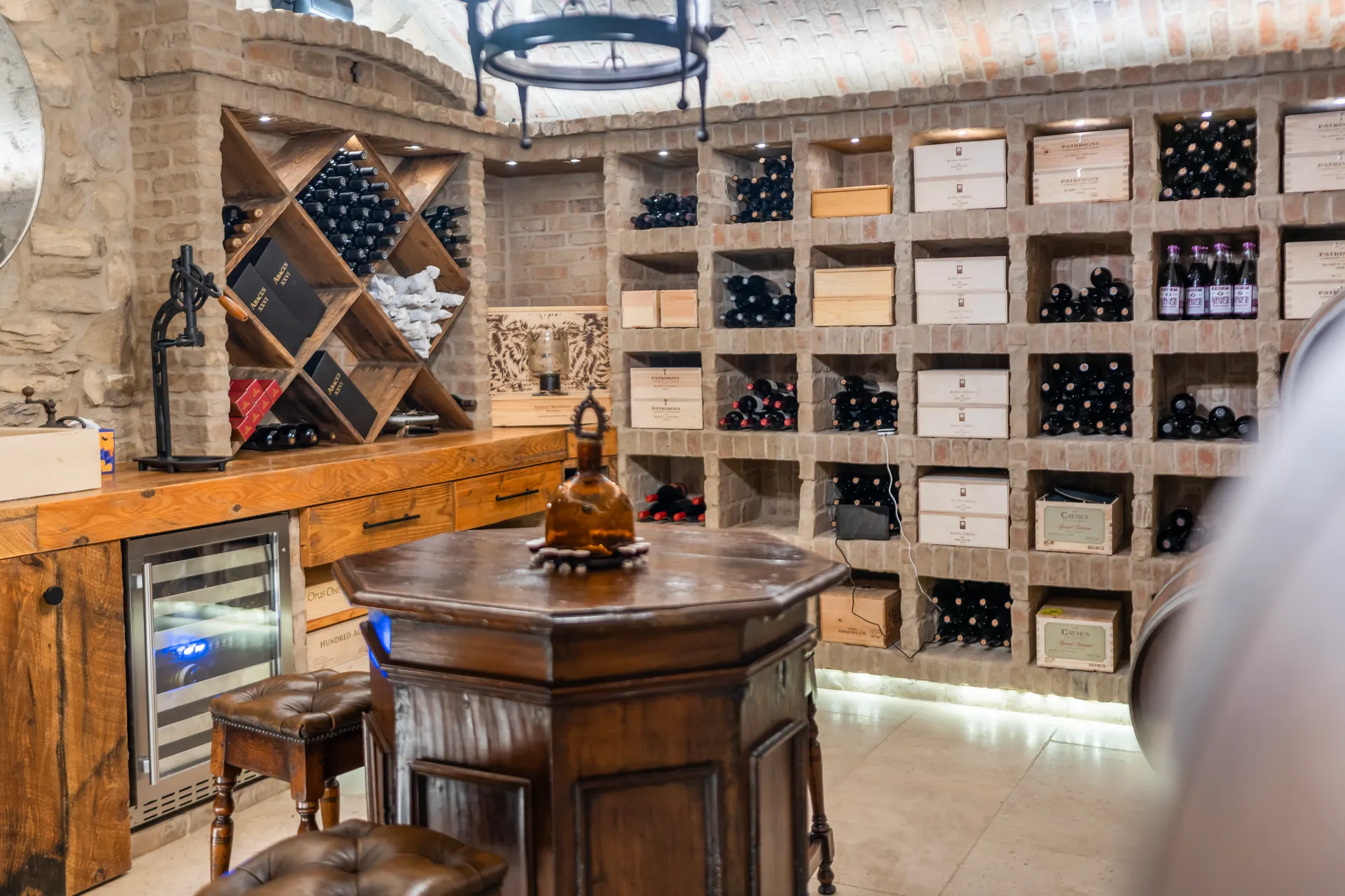 Wine racks and a timber tasting table with a chilled cabinet set into the run