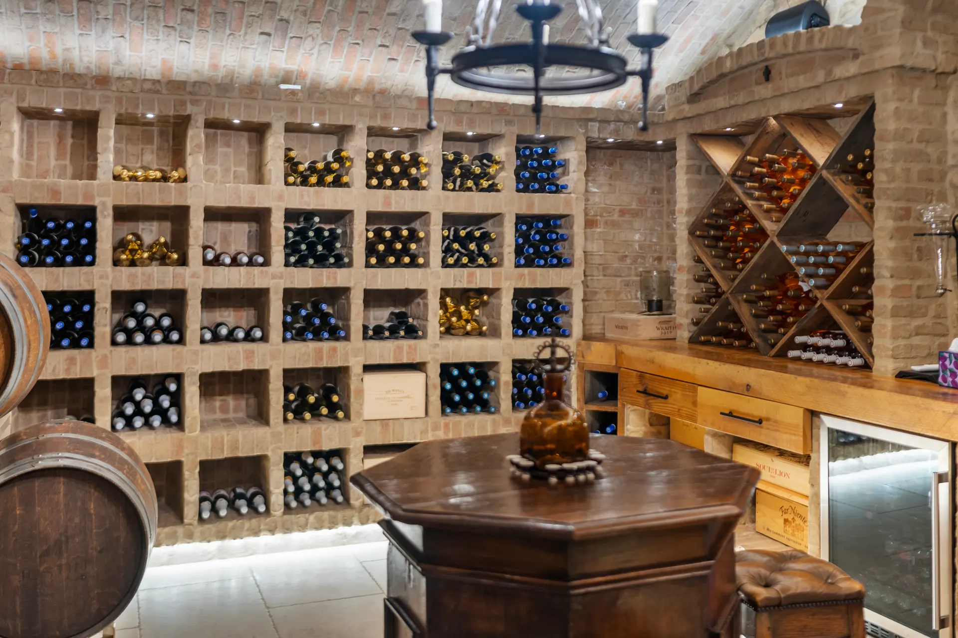 Length of the cellar with an iron chandelier above the tasting table