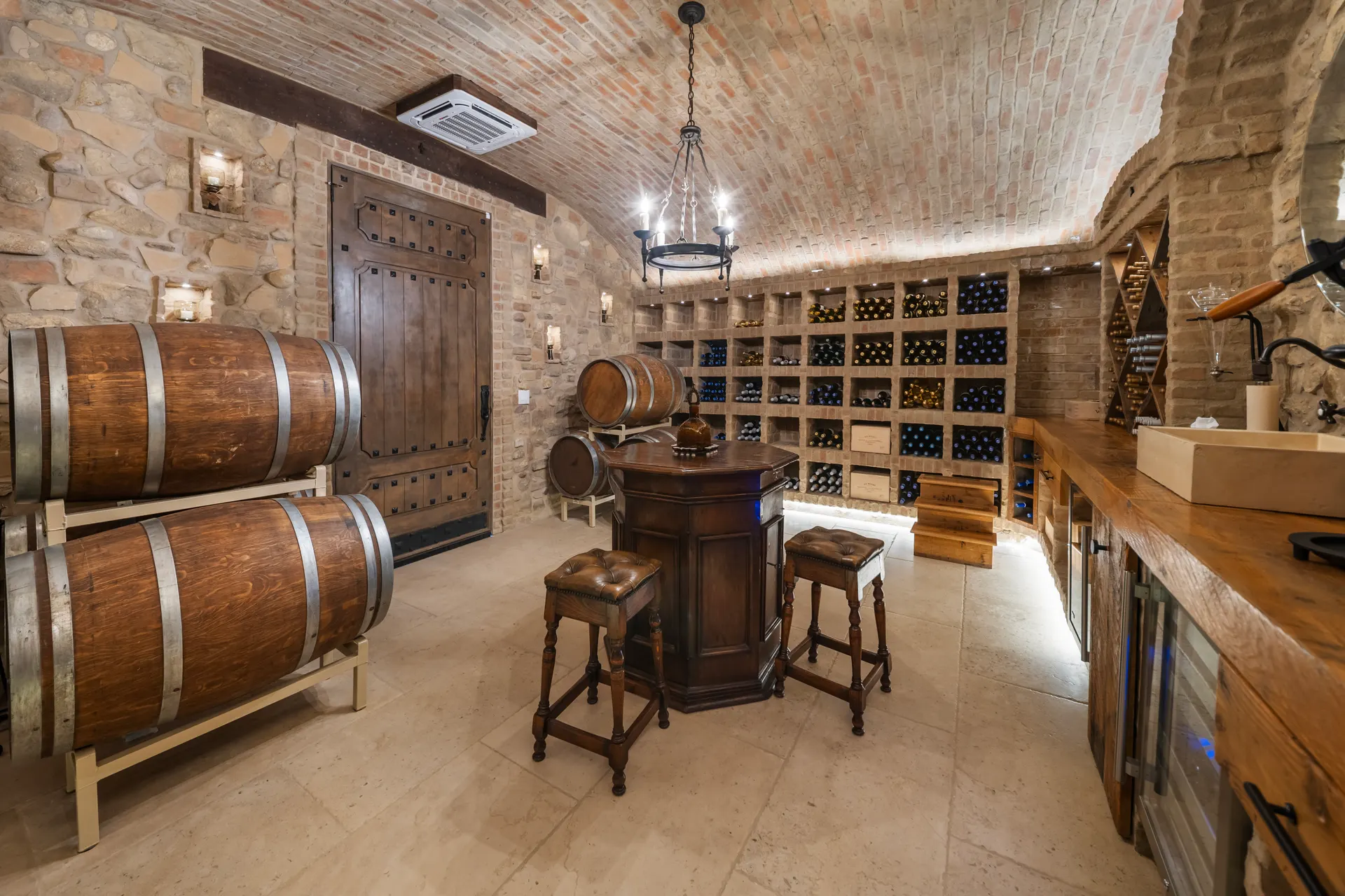 Cellar doorway with barrels alongside and racks running the length of the wall